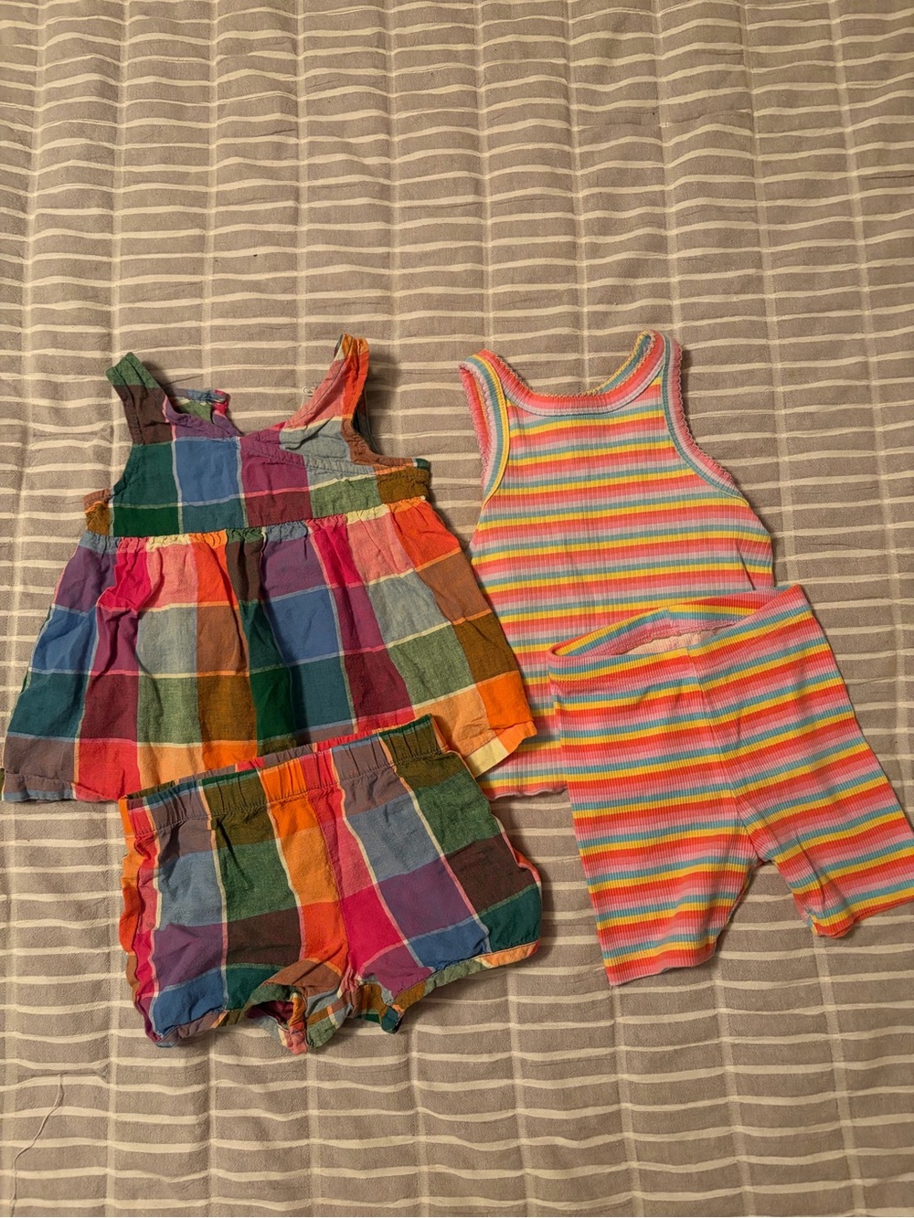 Two sets of colorful toddler outfits